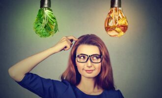 Woman deciding on diet - junk food or vegetables