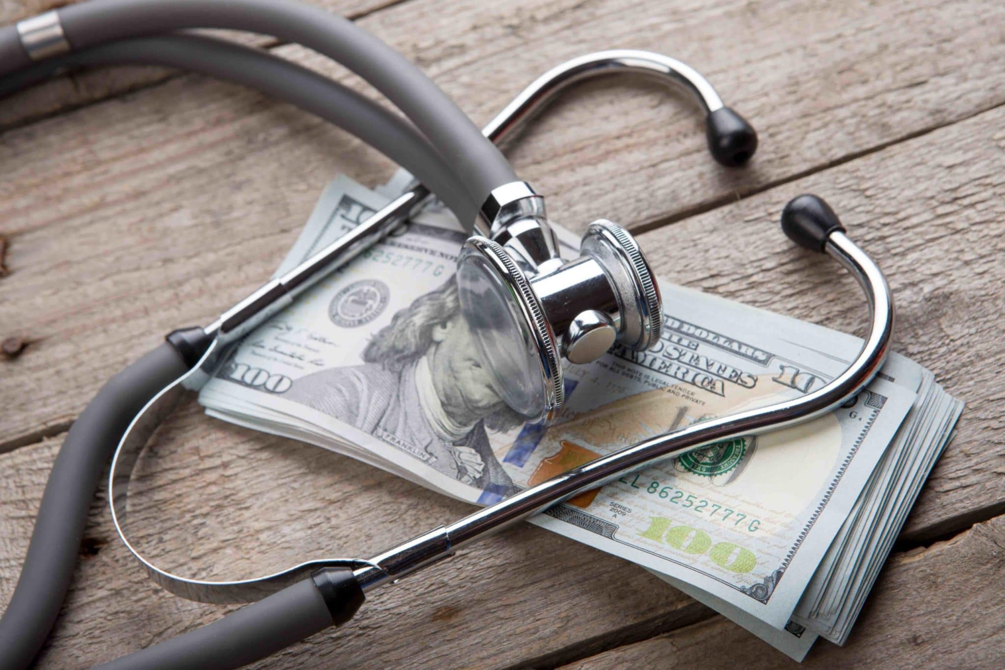 Stethoscope and money on table