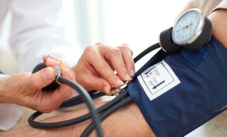 Physician measuring blood pressure