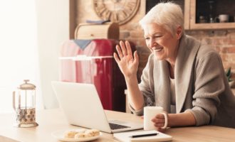 Elderly woman making video call on laptop