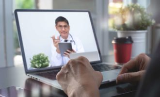 Physician talking to patient via telehealth