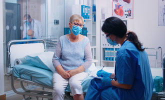 Nurse questioning senior patient