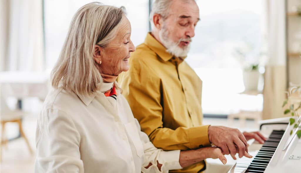 Elder couple playing piano